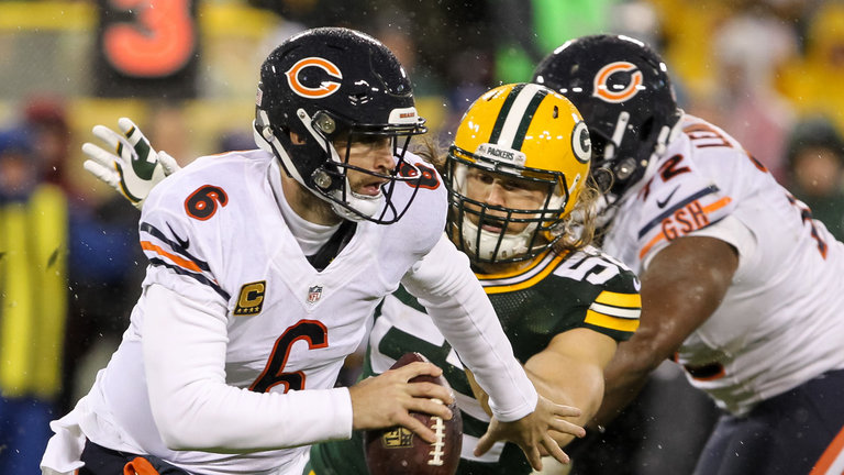 Quarterback Jay Cutler #6 of the Chicago Bears evades Clay Matthews #52 of the Green Bay Packers