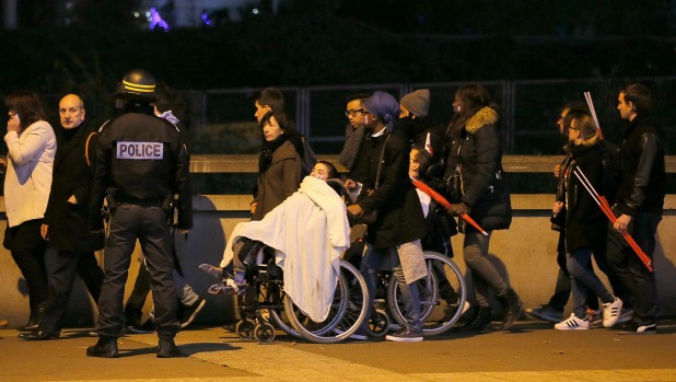 Police control crowds leaving the Stade de France where explosions were reported to have detonated outside the stadium