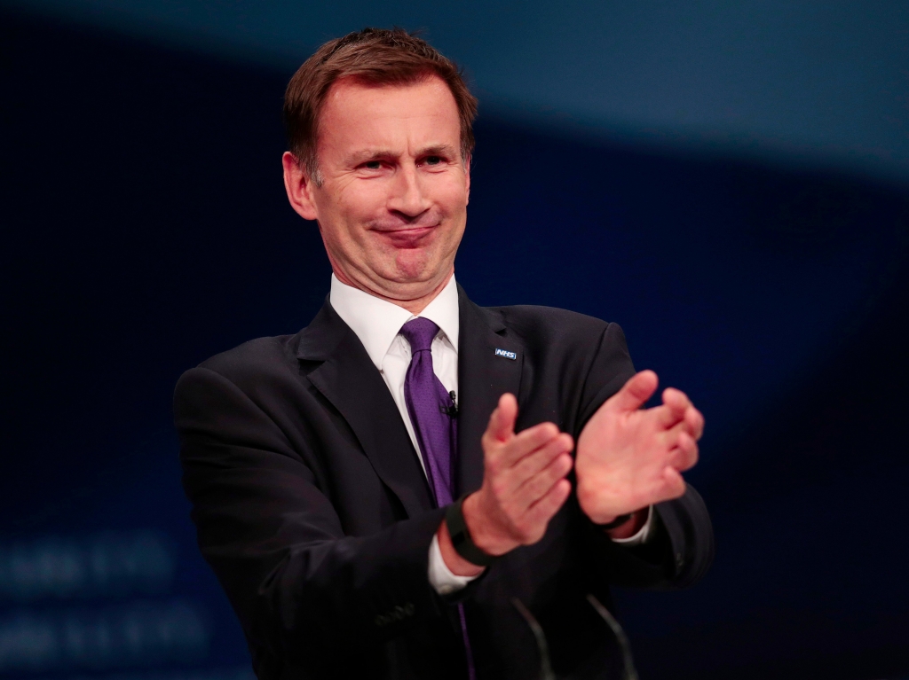 Britain's Health Secretary Jeremy Hunt applauds his staff members at the opening of his speech at the Conservative Party Conference in Manchester Britain