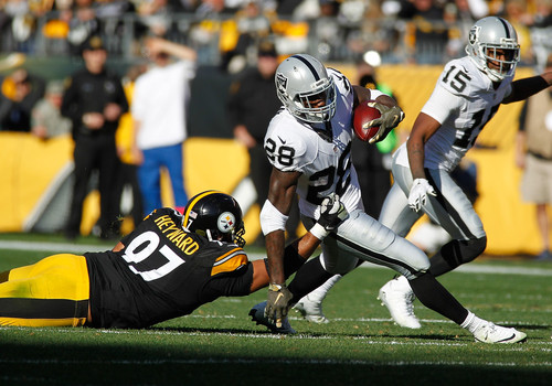 Cameron Heyward #97 of the Pittsburgh Steelers tackles Latavius Murray #28 of the Oakland Raiders during the first half of the game at Heinz Field