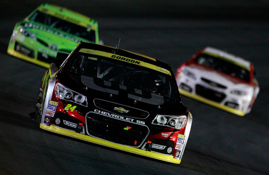 Jeff Gordon #24 Drive To End Hunger Chevrolet leads Kyle Busch #18 Doublemint Toyota and Kevin Harvick #4 Budweiser Chevrolet during the NASCAR Sprint Cup Series Bank of America 500 at Charlotte Motor Speedway