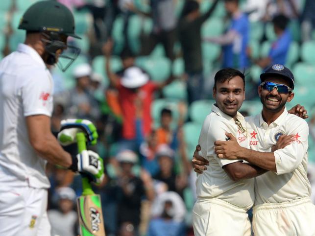 India`s Amit Mishra and teammate Ajinkya Rahane celebrate after the dismissal of South Africa`s Faf du Plessis during play on the third day of the third Test cricket match between India and South Africa at The Vidarbha Cricket Association Stadium