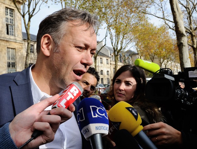 Karim Benzema's lawyer Sylvain Cormier answers questions as he meets the media in front of a police station in Versailles south of Paris France where his client is being questioned Wednesday Nov. 04 2015. France striker Karim Benzema will remain