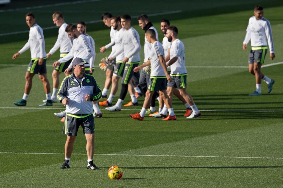 Real Madrid players run behind head coach Rafael Benitez foreground during a training session in Madrid Spain Friday Nov. 20 2015. Real Madrid and Barcelona will play at the Santiago Bernabeu Stadium on Saturday in the first clasico of the season. P