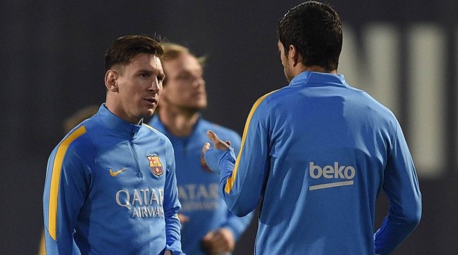 Barcelona's forward Lionel Messi talks with forward Luis Suarez during a training session at the Sports Center FC Barcelona Joan Gamper in Sant Joan Despi near Barcelona