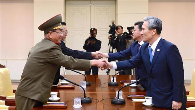 Representatives from North Korea and the South shake hands as they meet at the village of Panmunjom