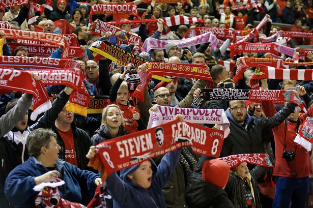 Liverpool fans hold up scarves during the game