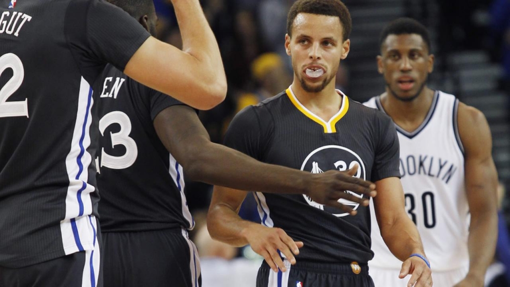 Golden State Warriors Stephen Curry celebrates with teammates their overtime win against the Brooklyn Nets Saturday Nov. 14 2015 in Oakland Calif