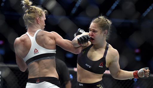 Holly Holm left and Ronda Rousey exchange their punches during their UFC 193 bantamweight title fight in Melbourne Australia Sunday Nov. 15 2015. Holm pulled off a stunning upset victory over Rousey in the fight knocking out the women's bantamweigh