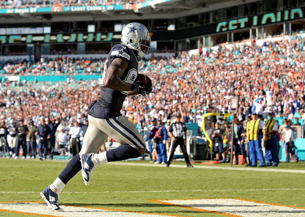 MIAMI GARDENS FL- NOVEMBER 22 Dez Bryant #88 of the Dallas Cowboys catches a touchdown pass in the end zone during the second half of the game against the Miami Dolphins at Sun Life Stadium