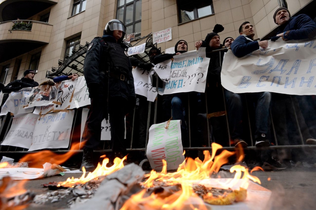 Protesters hold placards and shout slogans as they take part in an anti Turkey picket outside the Turkish embassy in Moscow