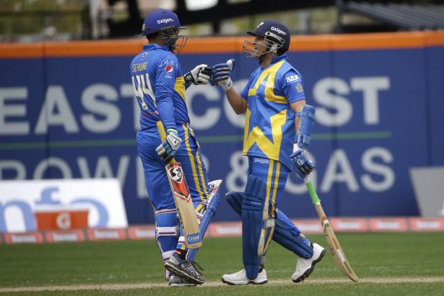 Sachin Tendulkar and Virender Sehwag celebrate after Tendulkar hit a 6 during the Blasters innings of the first game of the Cricket All Stars series games at Citi Field in New York