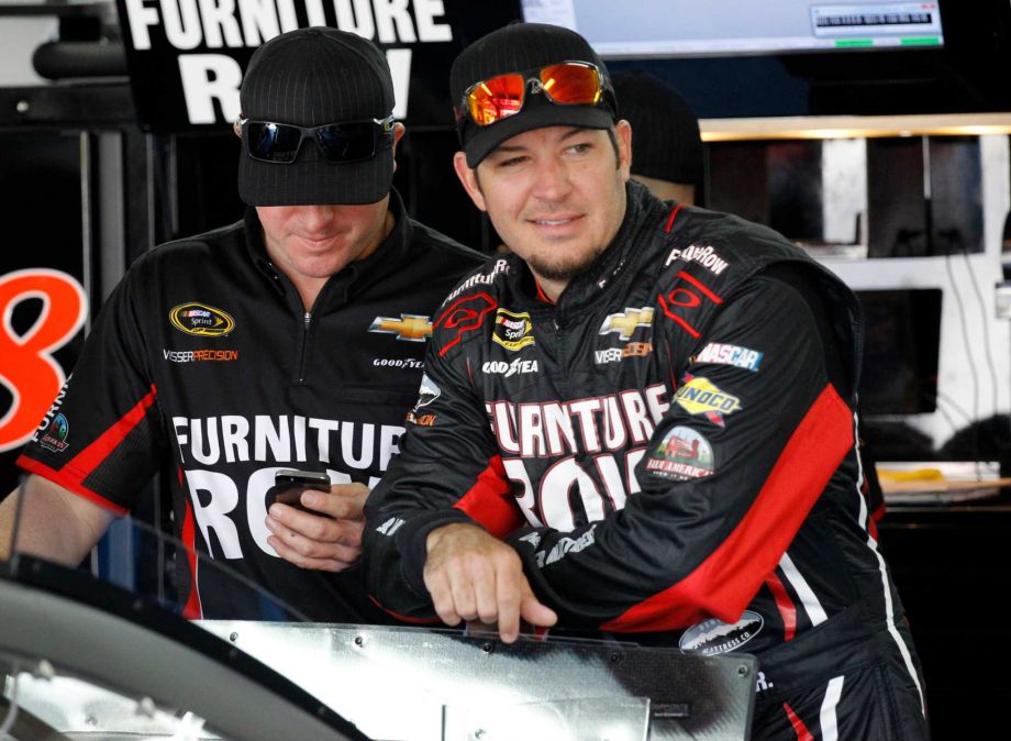 Martin Truex Jr right looks out of the garage before practice for Sunday's NASCAR Coca Cola 600 Sprint Cup series auto race at Charlotte Motor Speedway in Concord N.C. With only three career wins in 368