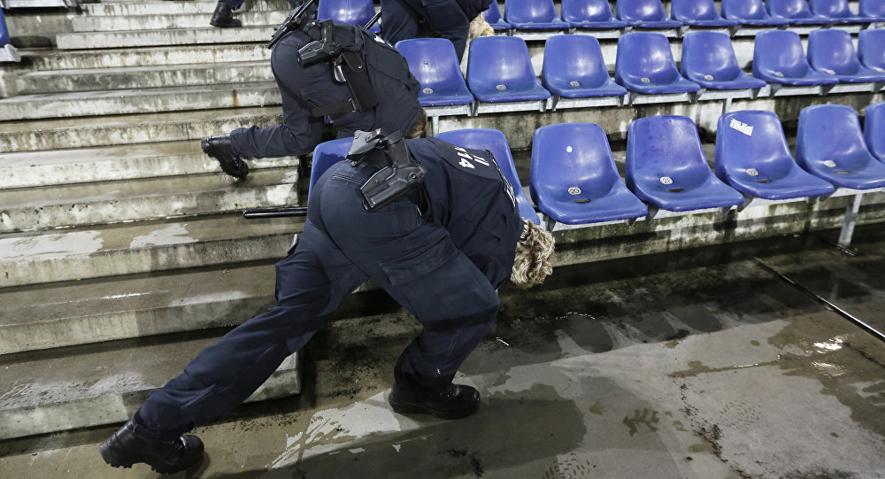 German police officers search between the seats of the stadium prior to an international friendly soccer match between Germany and the Netherlands in Hannover Germany Tuesday Nov. 17 2015