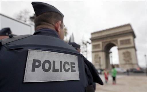 Police forces patrol near the landmark the Arc de Triomphe in Paris Tuesday Nov. 17 2015. France's Interior Minister Bernard Cazeneuve has said that authorities carried out'128 police raids last night following Friday's deadly Paris atta