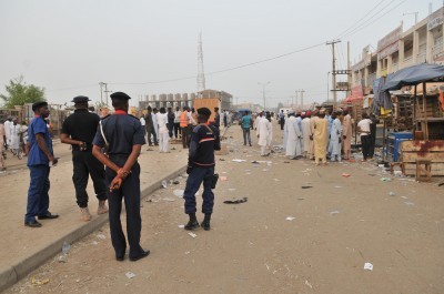 Security officers stand guard at the scene of an explosion at a mobile phone market in Kano Nigeria. Wednesday