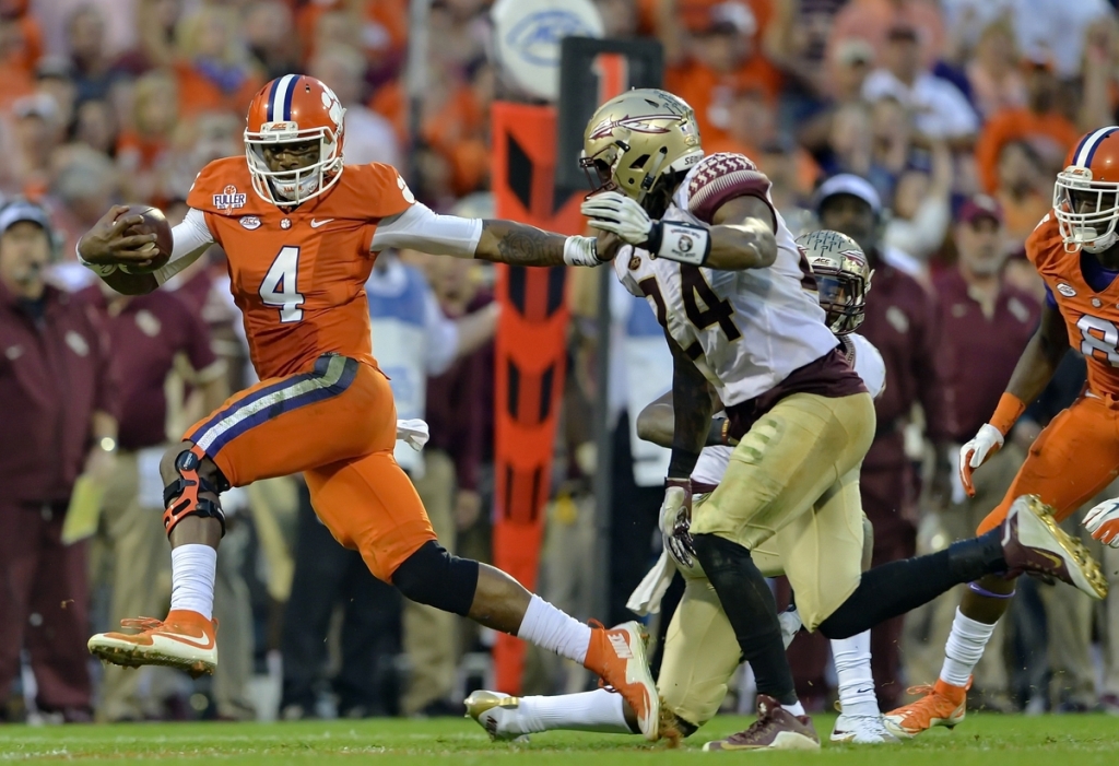 Clemson's Deshaun Watson fends off Florida State's Terrance Smith to gain a first down during the first half of Saturday's game in Clemson S.C. The Tigers own 23-13