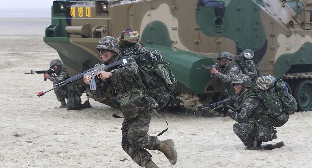 South Korean Marines come out from a landing craft during a landing exercise on the beach in Taean western South Korea Monday