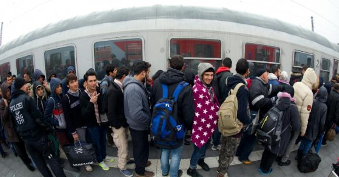 Migrants enter a special train to bring them to Duesseldof western Germany on a platform of the railway station in Passau southern Germany