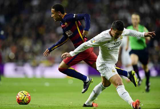 Real Madrid’s Colombian midfielder James Rodriguez vies with Barcelona’s Brazilian forward Neymar during the Spanish league “Clasico” football match Real Madrid CF vs FC Barcelona at the Santiago Bernabeu stadium in Madrid on Saturday (Sun