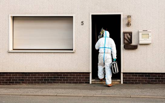 A police investigator in protective cloth enter a house in Wallenfels southern Germany Friday morning Nov. 13 2015 where police found bodies of multiple babies