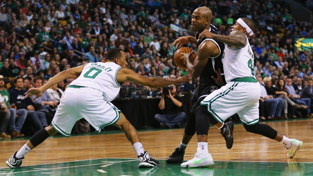 Shane Larkin #0 of the Brooklyn Nets drives against Isaiah Thomas #4 of the Boston Celtics and Avery Bradley #0