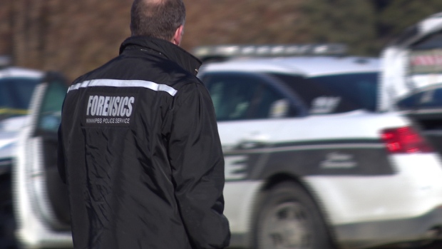 A member of the forensics unit stands near Lipsett Hall at the former Kapyong Barracks military site on Saturday where the shooting took place on Friday