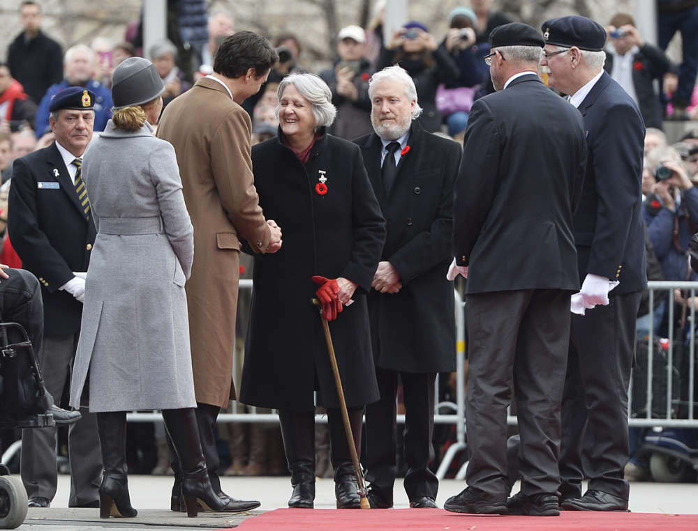 Prime Minister Justin Trudeau greets the Royal Canadian Legion's Silver Cross mother Sheila Anderson during the Remembrance Day ceremony at the National War Memorial in Ottawa on Wednesday Nov. 11 2015. iPolitics  Matthew Usherwood