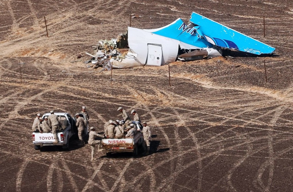 Russian Ministry for Emergency Situations Egyptian military personnel approach the Metrojet plane's tail at the wreckage site in Hassana Egypt on Sunday. Russian Ministry for Emergency Situations via AP