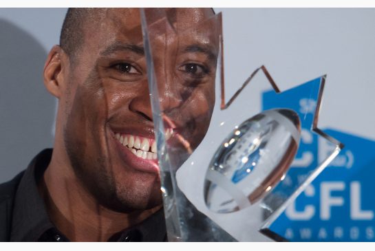 Ottawa Redblacks quarterback Henry Burris shows off the CFL's most oustanding player award which he won Thursday night