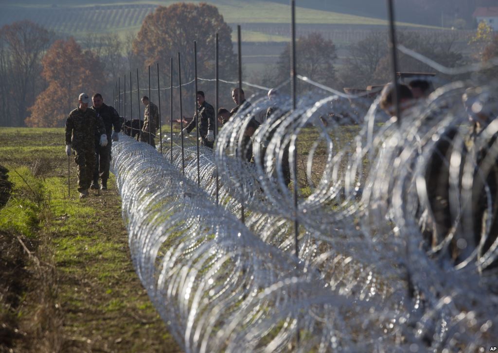 Slovenian soldiers erect a razor-wired fence on the Croatian border in Gibina Slovenia Nov. 11 2015. The government aims to prevent the uncontrolled entry of more migrants in the already-overwhelmed alpine state