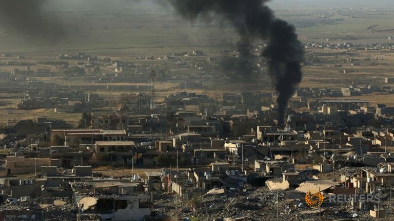 Smoke rises from the site of U.S.-led air strikes in the town of Sinjar