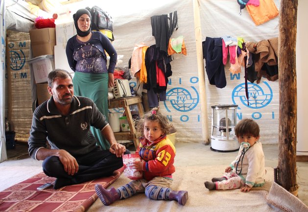 A Yazidi family of four in the makeshift shelter they hope to soon leave when they return to Sinjar