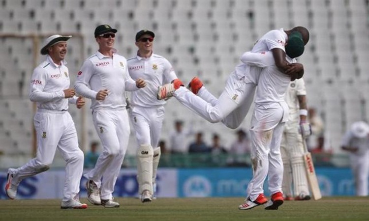 South Africa's Rabada celebrates with teammates after dismissing India's captain Kohli during the first day of their first cricket test match in Mohali