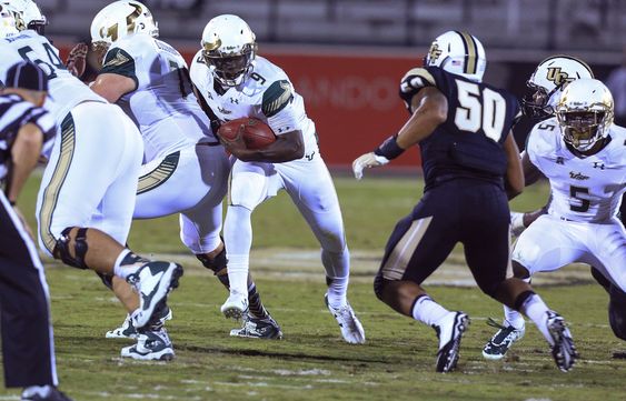 Quinton Flowers is stopped by Central Florida's Dominic Spencer as he runs up the middle during the first quarter of an NCAA college football game Thursday Nov. 26 2015 in Orlando Fla. (Joshua C. Cruey  Orlando