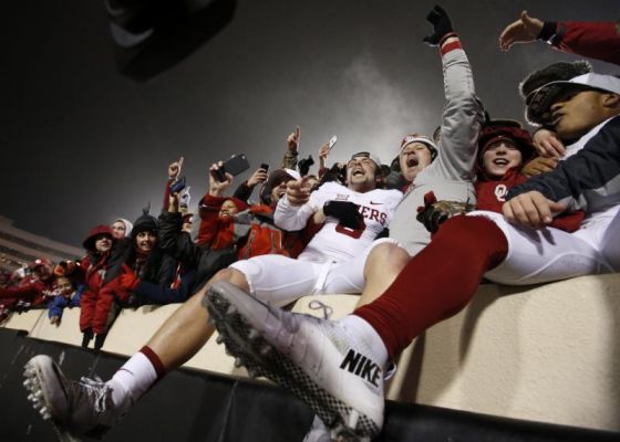 Oklahoma quarterback Baker Mayfield center celebrates with fans