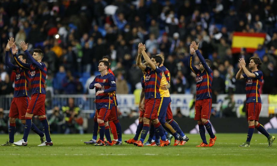 Barcelona's players celebrate their victory at the end of the first clasico of the season between Real Madrid and Barcelona at the Santiago Bernabeu stadium in Madrid Spain Saturday Nov. 21 2015