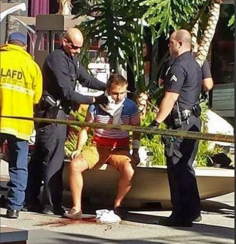 Brown authorities care for a man after he was stabbed on the Hollywood Walk of Fame in Los Angeles Wednesday Nov. 18 2015. Police say the tourist was attacked across from the TLC Chinese Theatre. Phot