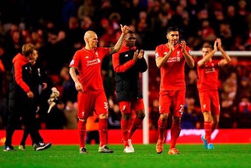 Emre Can Christian Benteke and Martin Skrtel of Liverpool applaud the crowd after the Barclays Premier League match between Liverpool and Swansea City at Anfield