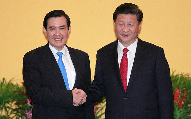 Taiwan's President Ma Ying-jeou and China's President Xi Jinping having their historic hand shake Singapore's Shangri-la Hotel