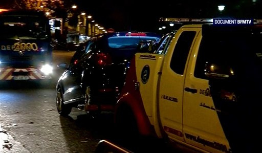 This image taken from BFMTV shows a car being towed away accompanied by security vehicles in Montreuil a suburb of Paris overnight Saturday  Sunday Nov. 14/15 2015. A Seat car with suspected links to the Paris attacks has been found by police in Montr