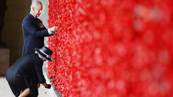 The Prince of Wales and Duchess of Cornwall place their poppies on the wall of remembrance in Canberra