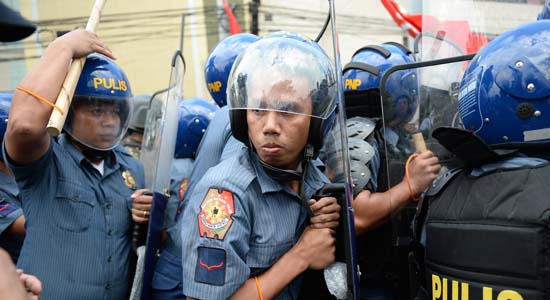 12								They too of the masses policemen form a line as they are confronted by protesters near the venue of a meeting by APEC leaders on Nov. 18.- AFP