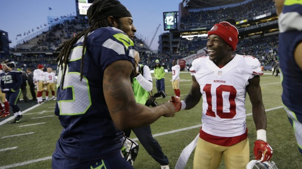 Friendly rivals Seattle cornerback Richard Sherman greets San Francisco wide receiver Bruce Ellington after the Seahawks defeated the 49ers 29-13 in Seattle