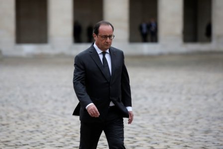 French President Francois Hollande walks in the courtyard of the Hotel des Invalides during a ceremony in Paris France