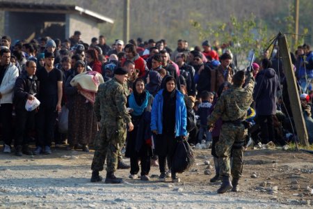 Migrants wait to enter a registration camp after they crossed the border from Greece in Gevgelija Macedonia