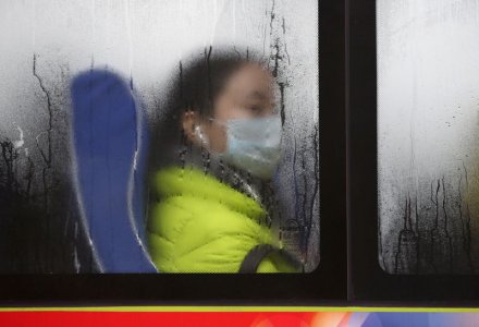 A passenger wearing a mask is seen in a bus during the morning rush hour in Beijing China