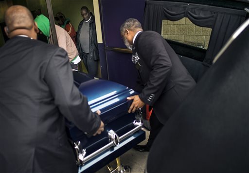 People carry the casket of Jamar Clark killed in the Nov. 15 shooting by Minneapolis police during his funeral at Shiloh Temple International Ministries in Minneapolis Minn. Wednesday Nov. 25 2015. Some community leaders called for peace on the day