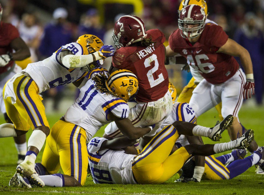 LSU's Jalen Mills Lamar Louis Tre'Davious White and Deion Jones converge on Alabama running back Derrick Henry last week. The Tigers host Arkansas Saturday night