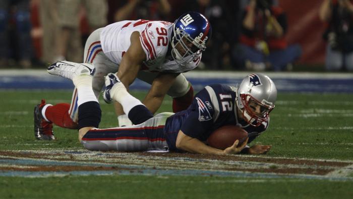 SUPER BOWL XLII- GLENDALE AZ 02/03/08- New England Patriots&apos Tom Brady #12 is sacked by New York Giants&apos Michael Strahan #92 in the second quarter. New England Patriots play against the New York Giants in Super Bowl XLII on Sunday February